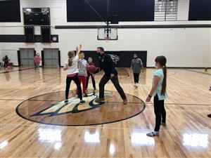 superintendent playing basketball with students